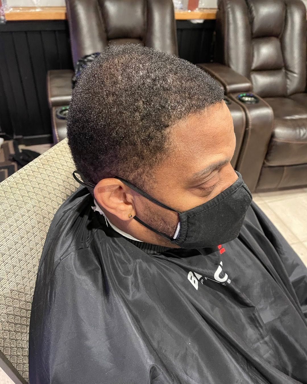 Side view of a short textured cut with a smooth taper and clean temple edge